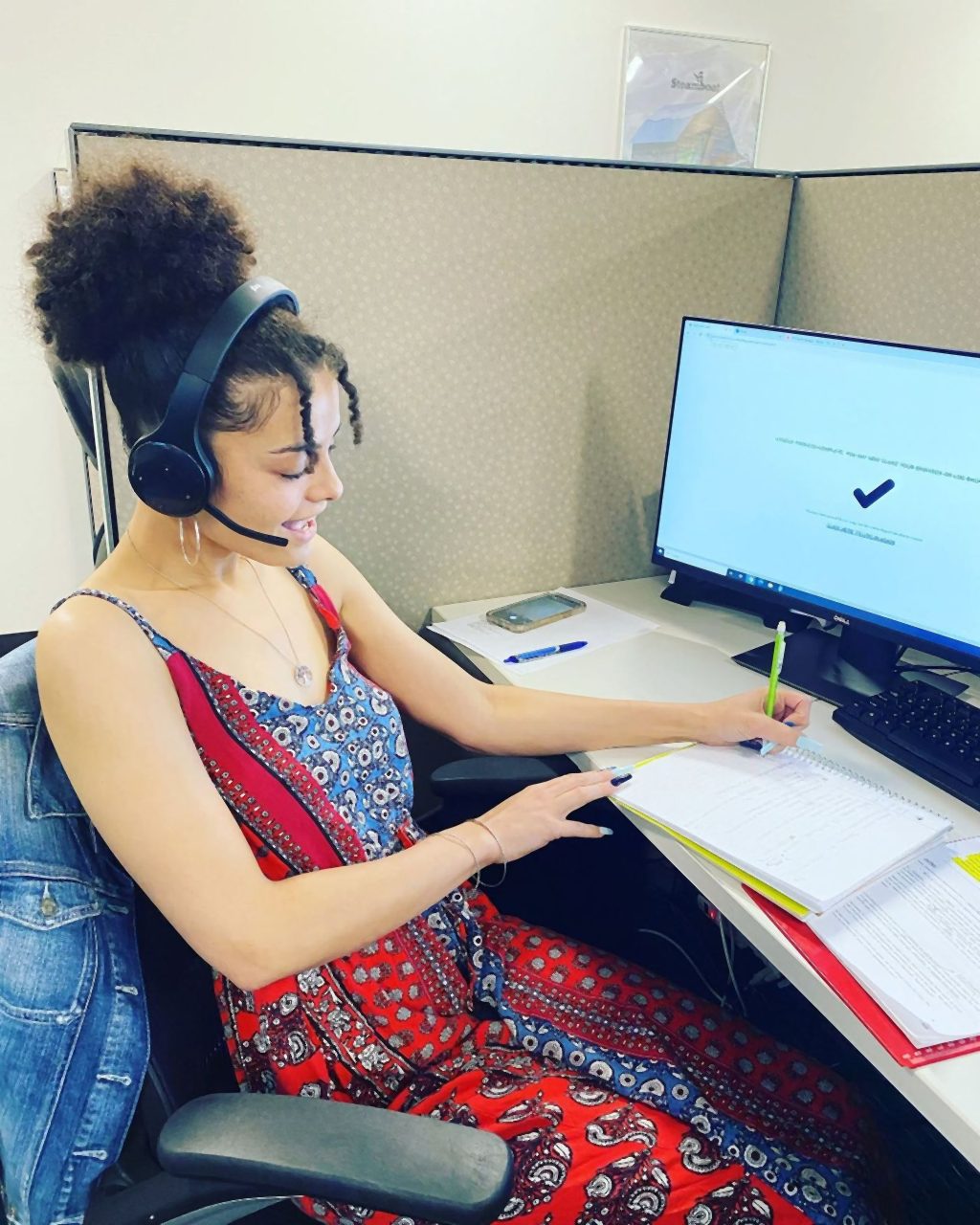 A Senior Solutions agent on a headset taking notes